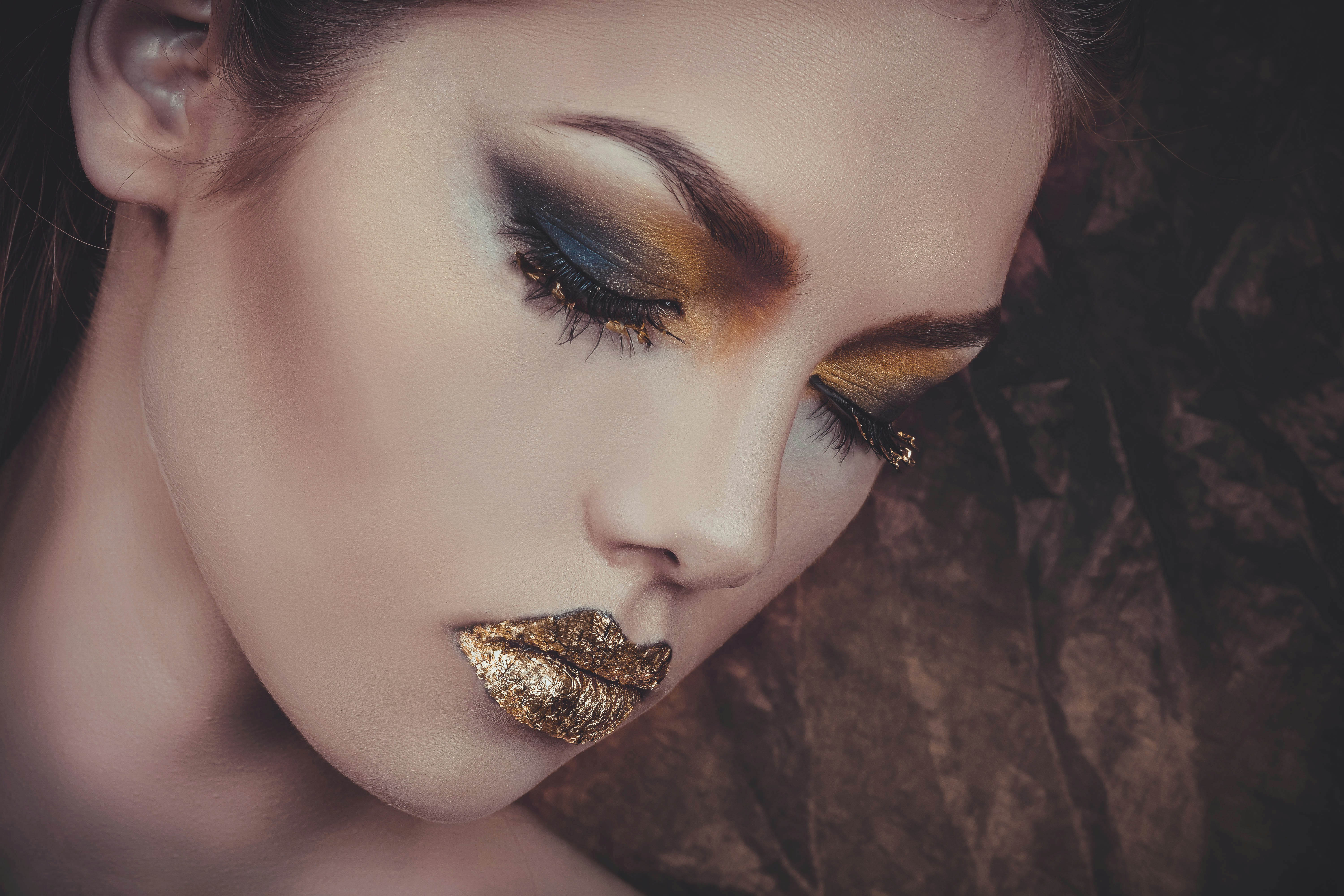 woman with gold lipstick and orange and gray eyeshadow