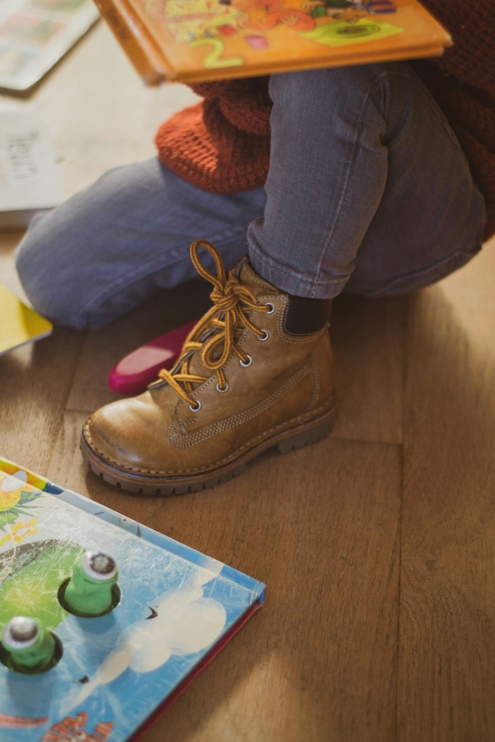 person wearing gray denim jeans and brown leather work boot ]