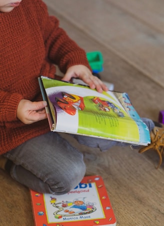 toddler holding storybook