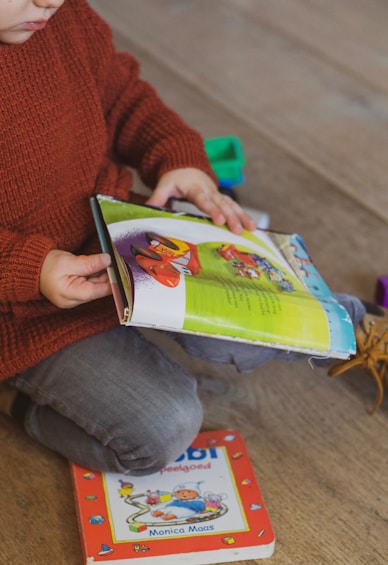 toddler holding storybook