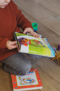 A toddler holding a storybook