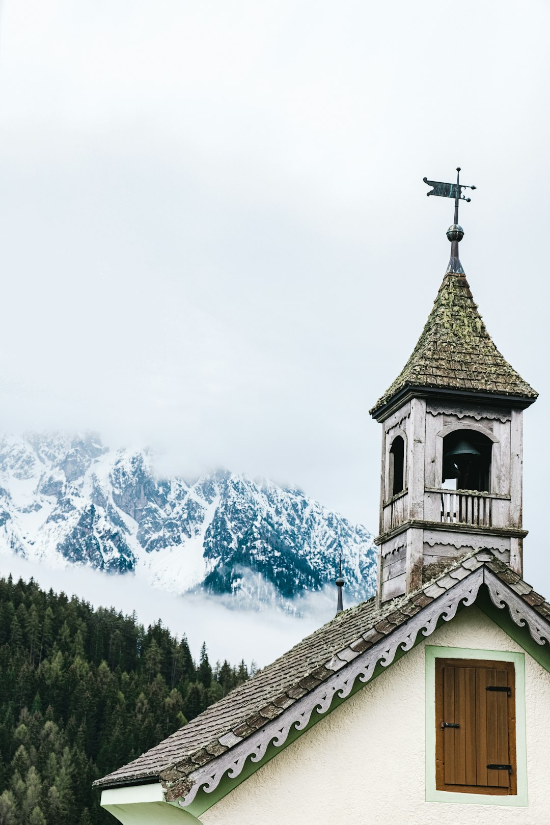 low-angle photo of green and white church