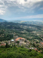 A panoramic view of the school building nestled in the lush hills of Desa Tanglad, Nusa Penida.