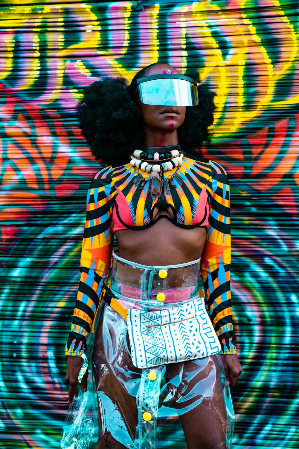 woman standing beside graffiti wall