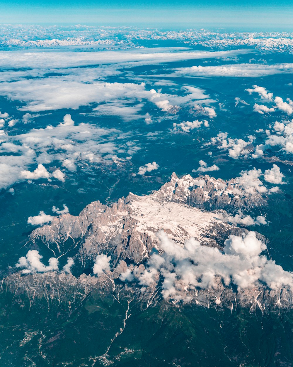 aerial photography of mountains under white clouds
