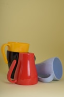 four assorted-color mugs