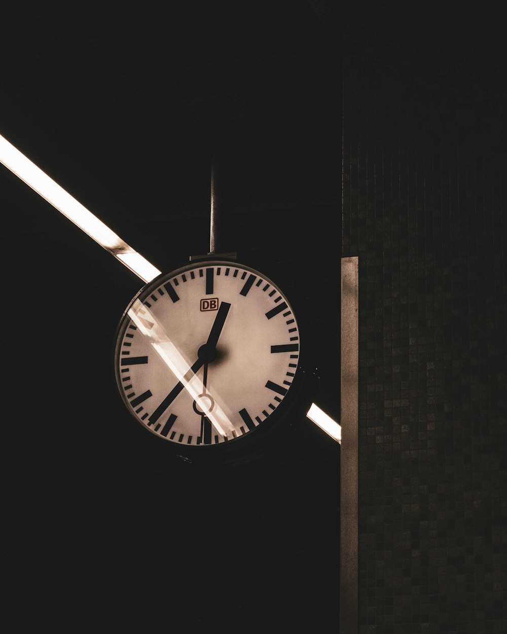 a clock hanging from the side of a building