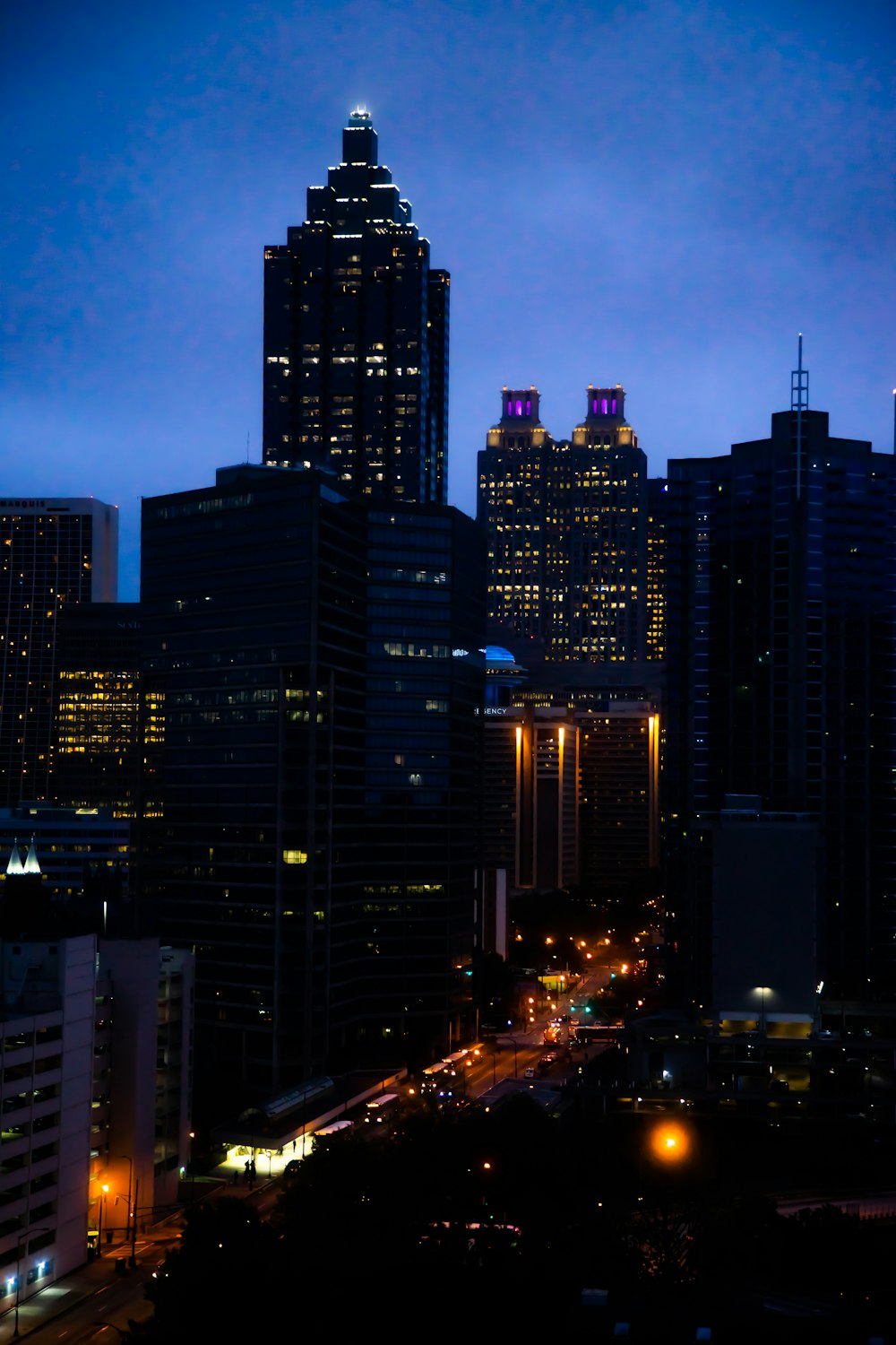 silhouette of city buildings during night time