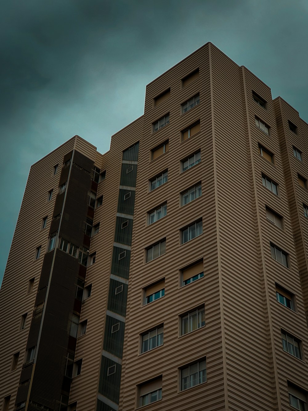 brown buildings under gray clouds