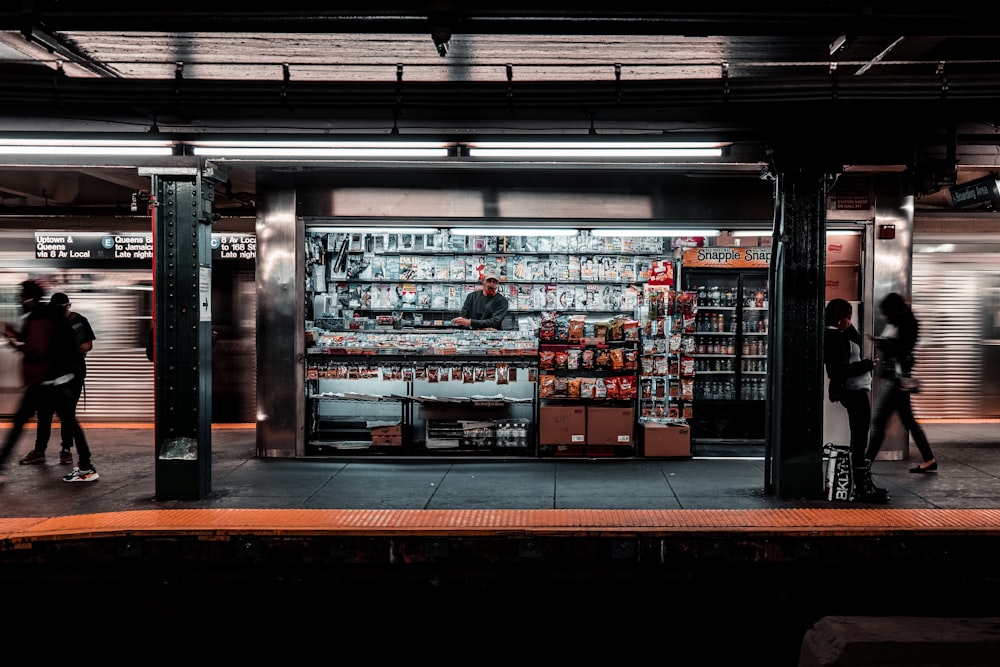 four person walking on train station