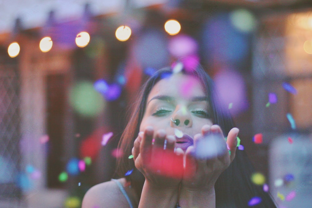 woman blowing confettis