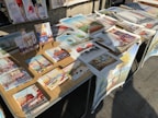 An array of colorful art prints arranged on a table.