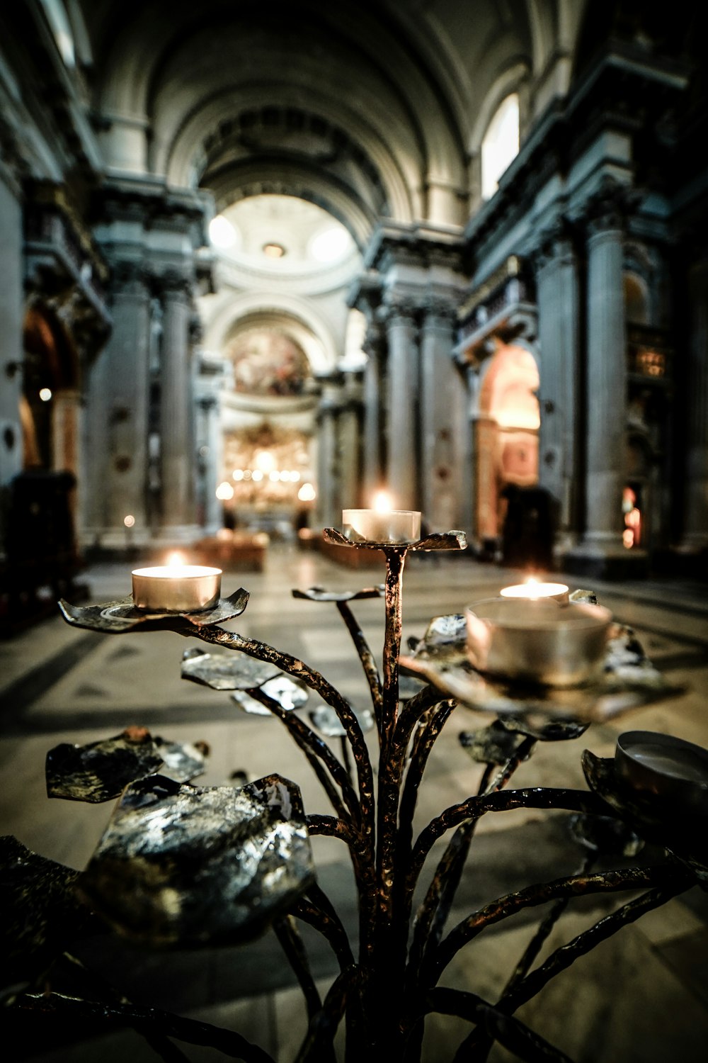 close-up photo of candelabra near inside dome building