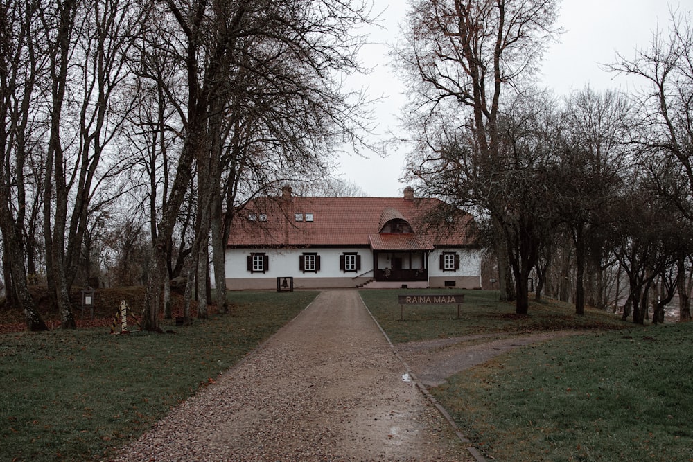 view photography of brown and white concrete house near trees during daytime