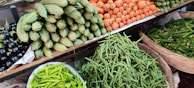 A variety of vegetables and legumes arranged for sale.