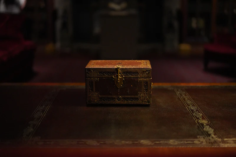A weathered pirate treasure chest filled with gold coins