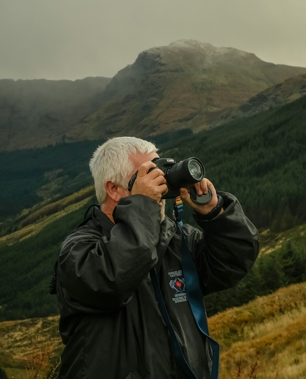 man taking pictures with camera