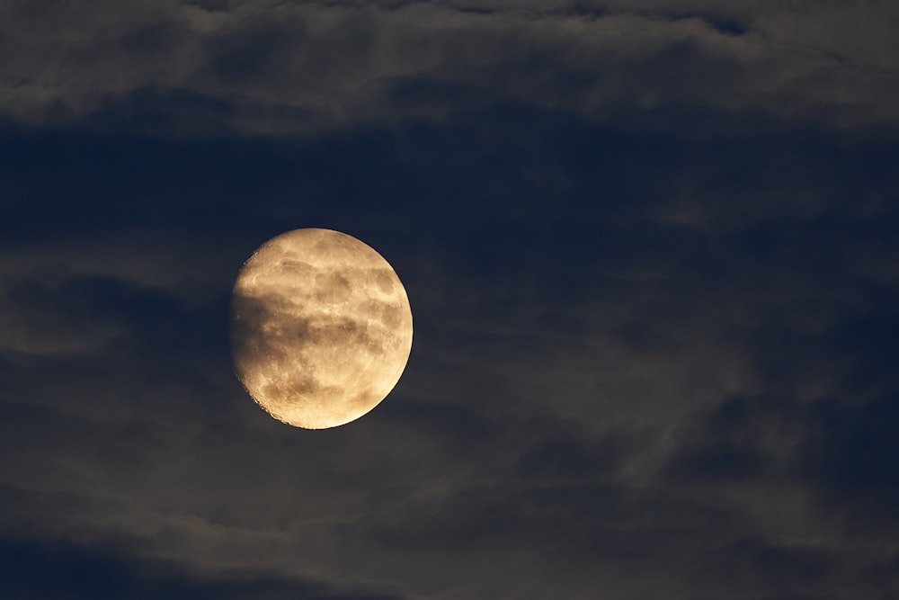 Earth's moon behind clouds