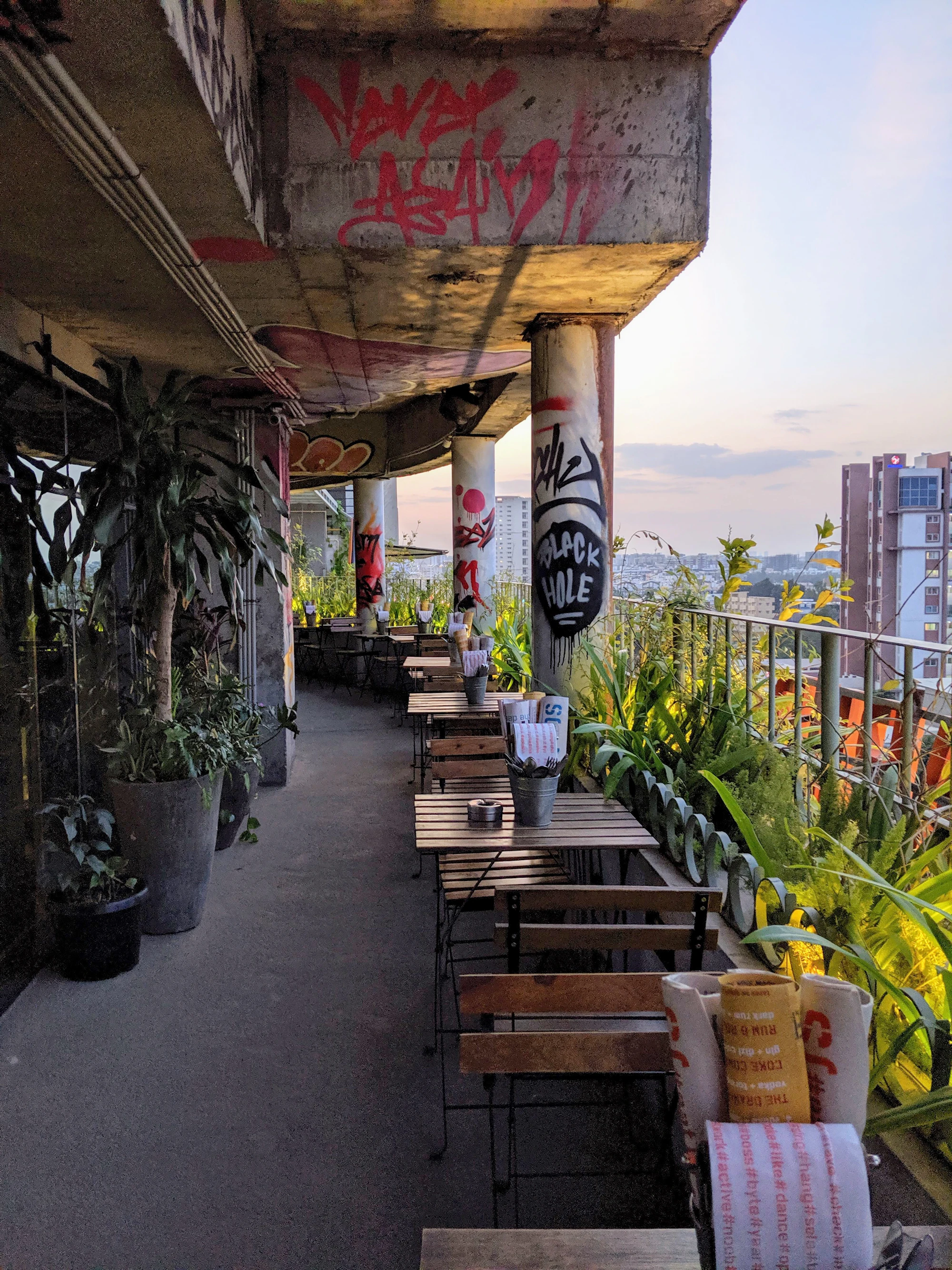 The covered terrace at Nalam Indiranagar, lined with plants