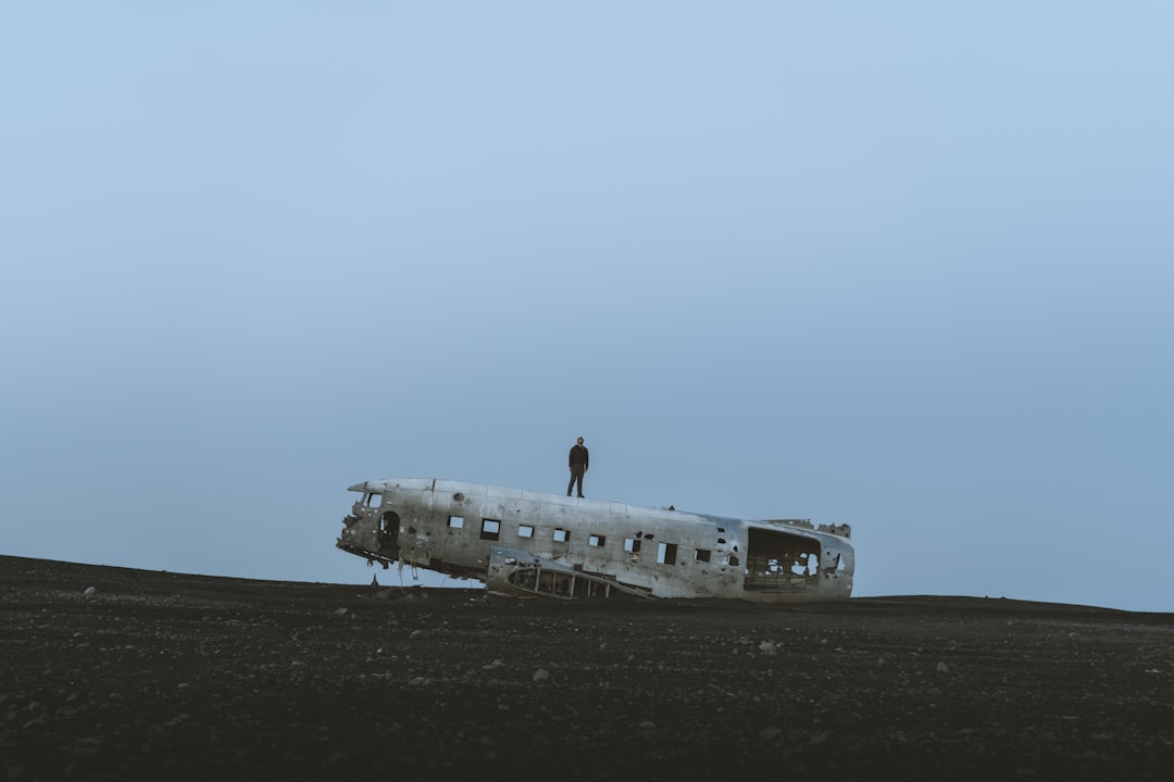 person standing on wrecked plane,