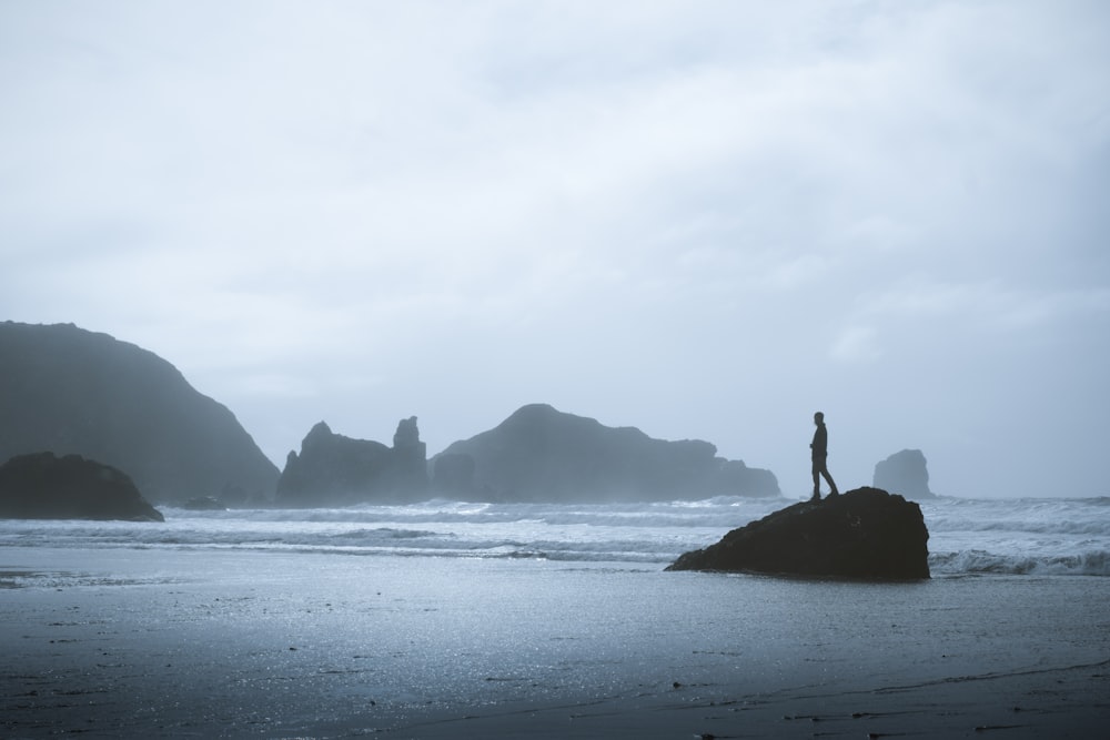 person standing on rock