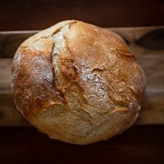 baked bread on wooden tray