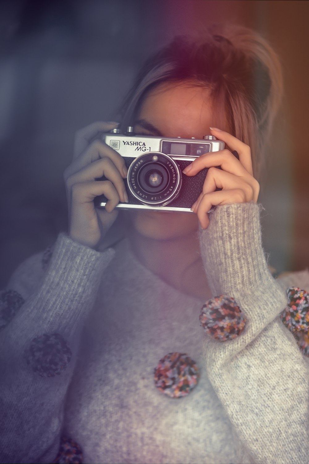 woman using silver and black DSLR camera