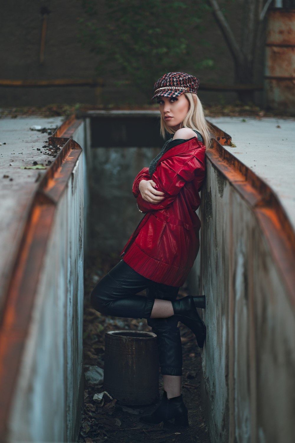 woman leaning on grey wall