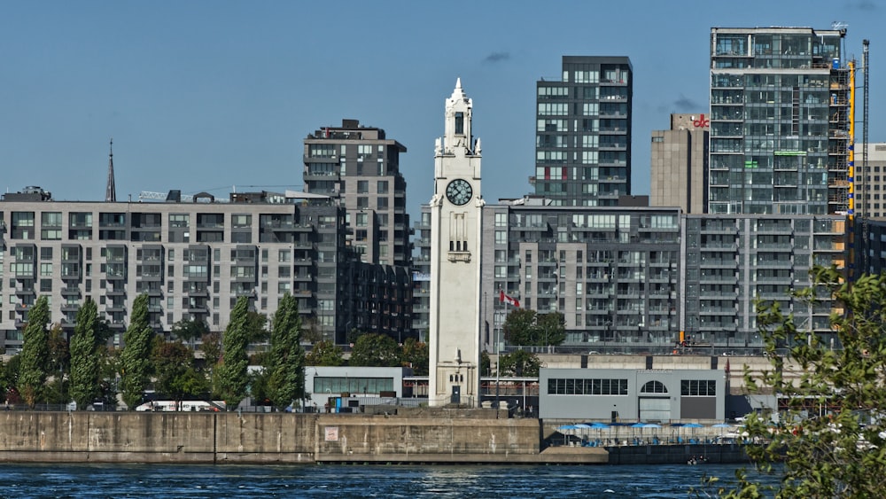 white tower clock beside body of water