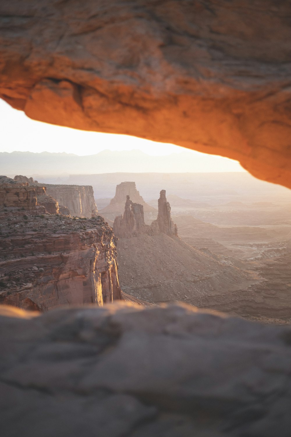 a view from inside a cave looking out at the desert