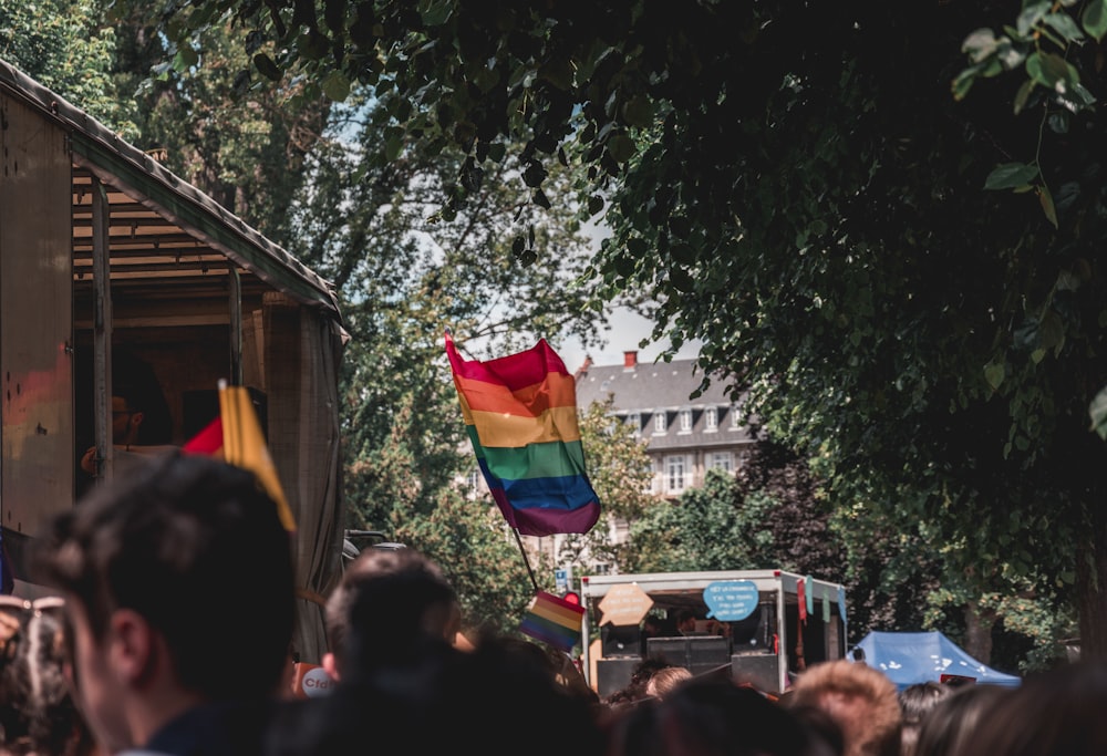 a crowd of people watching a gay pride parade