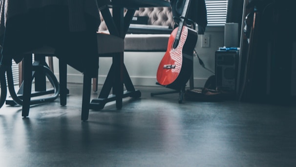 Guitarist practicing in an elegant, dimly lit room with a focus on black and gold decor.