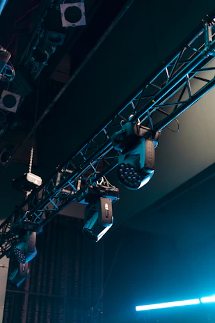Electrician setting up lighting equipment for a vibrant event stage