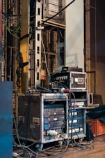 black and gray amplifier beside white and black surface