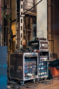 black and gray amplifier beside white and black surface