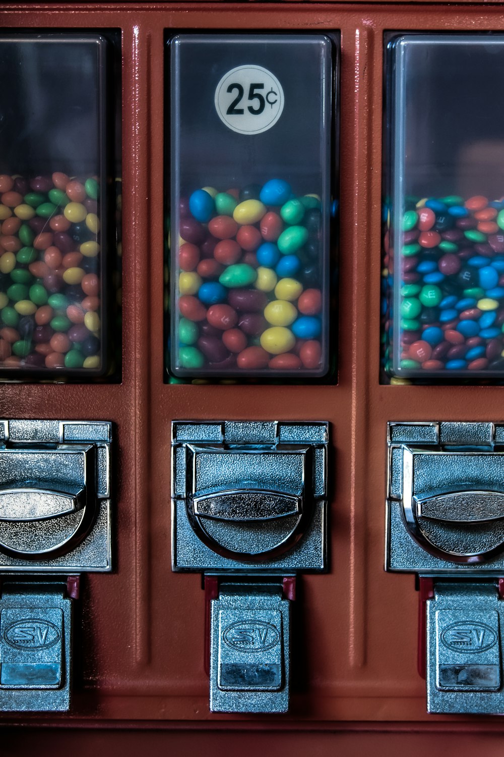 blue, yellow, and red candies on dispenser