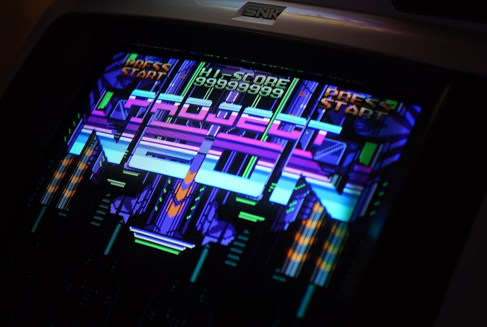 closeup photo of black and gray digital arcade game machine turned-on
