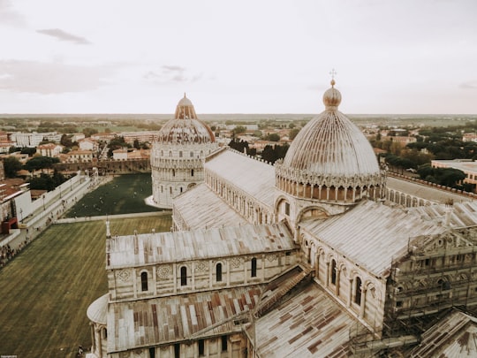 high-angle photo of white and brown concrete mosque in Cattedrale di Pisa Italy