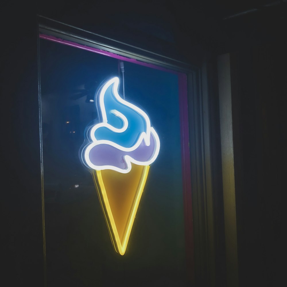 a neon ice cream sign in a window