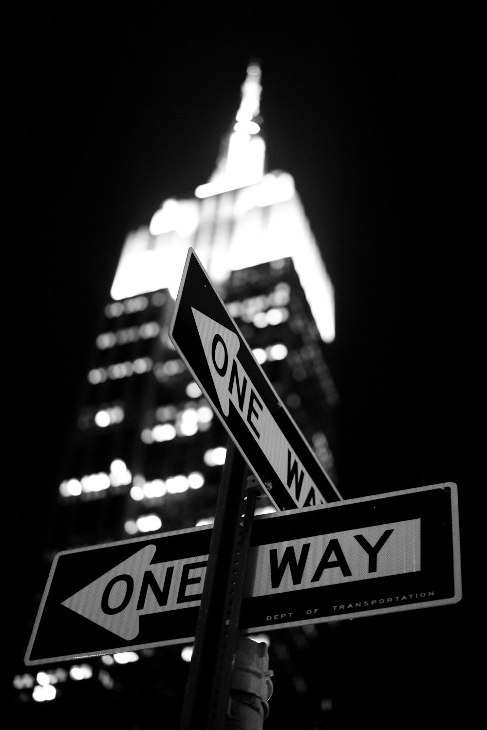 low-angle photography of One Way road sign at night