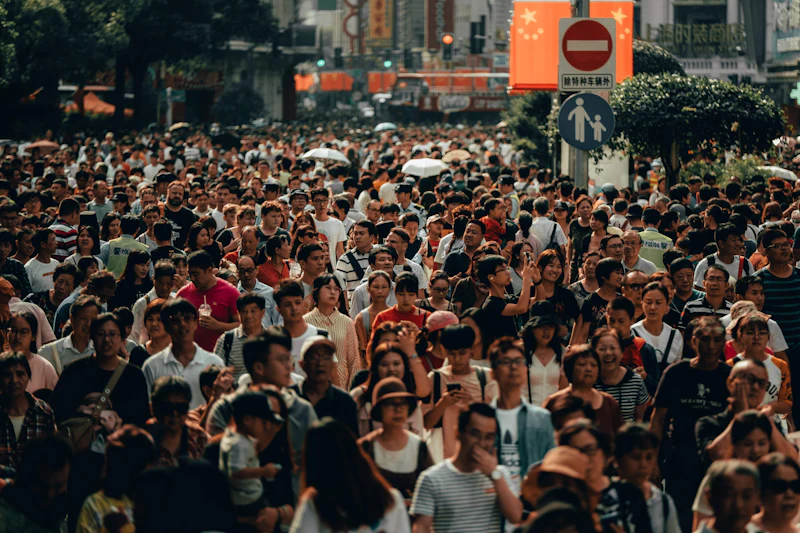 Dense crowd of people walking along a busy city street, a common place for phone theft