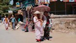 A summer street scene with girls in flowing ethnic skirts and casual tops.