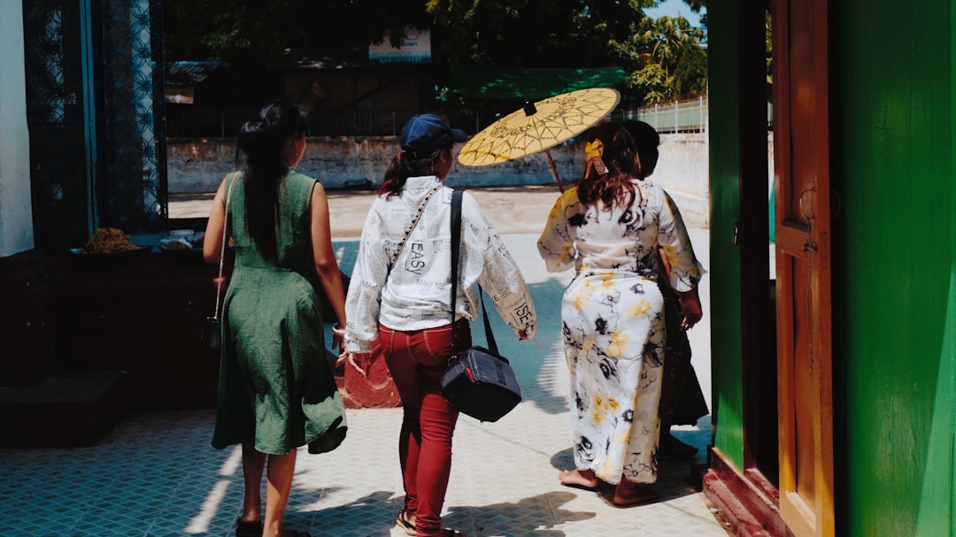 three women walking during daytime