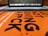 A close-up view of an orange book cover with bold black text, partially focusing on the words 'ART NOT GIVING A FCK'. In the background, a blurred laptop keyboard and screen are visible.