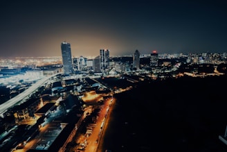 Nighttime city skyline with lights streaming, filmed with smooth tracking shots