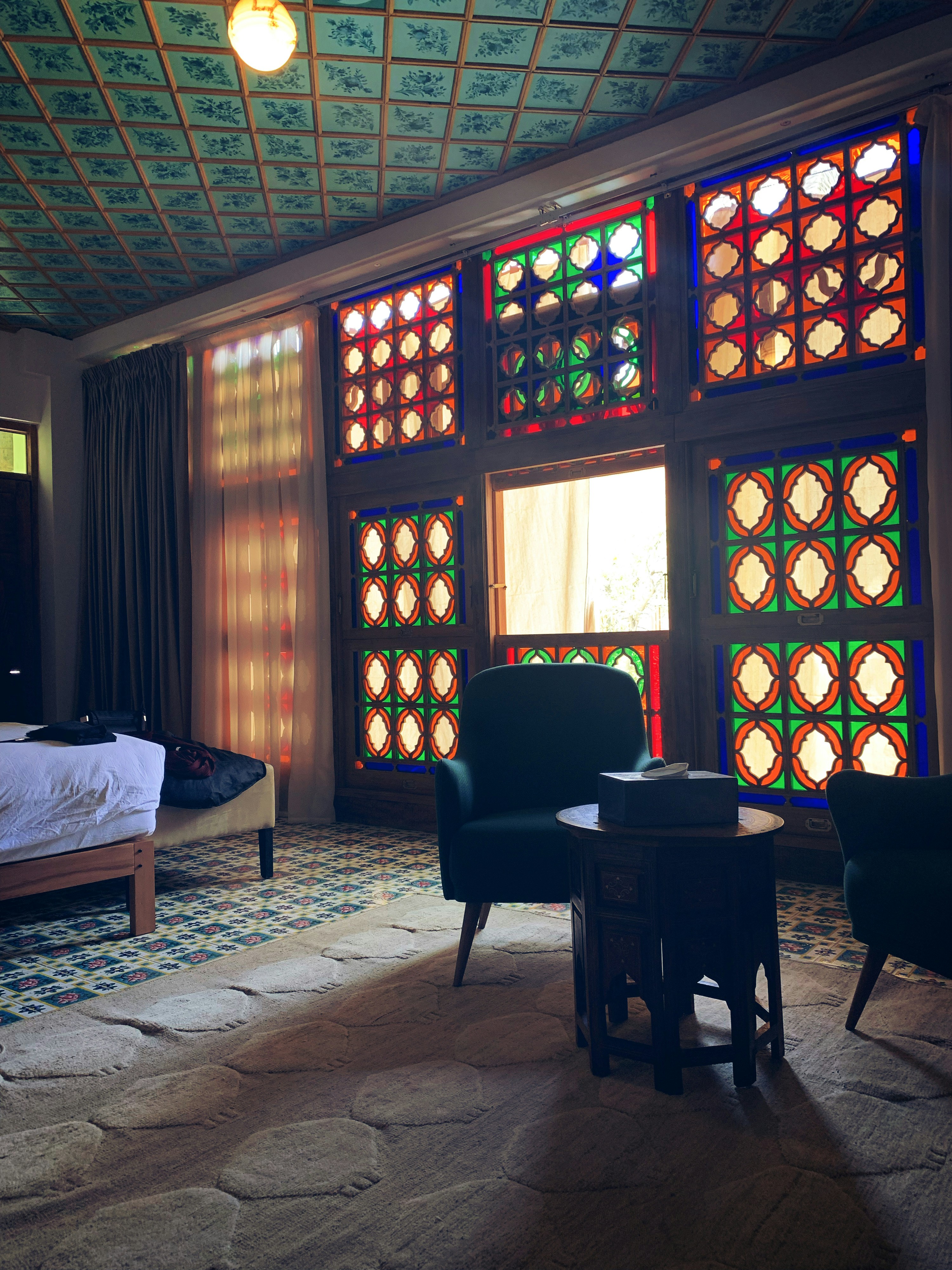 chairs, tables, and bed in room