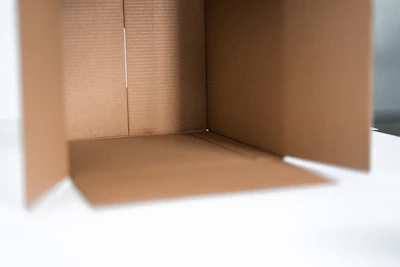 Close-up of a sleek storage box holding various office supplies in soft natural light.