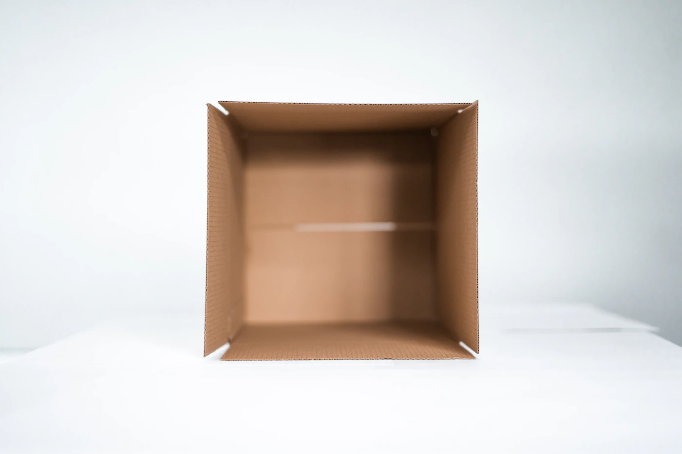 Open cardboard shipping box prepared for careful repacking