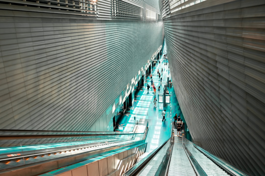 people walking inside building near escalator