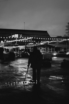 An outdoor scene showing a person navigating with a cane.